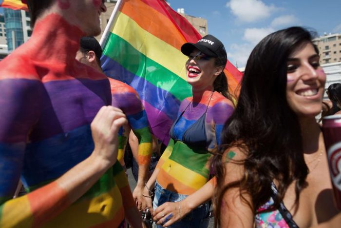 Israelis and foreigners celebrate during the 17th annual gay pride parade at the Israeli coastal city of Tel Aviv on June 12, 2015. According to the police some 170,000 Israelis and foreigners attended the march and at the end celebrate a huge party under the slogan Tel Aviv loves all Genders. AFP PHOTO /Menahem Kahana.MENAHEM KAHANA/AFP/Getty Images